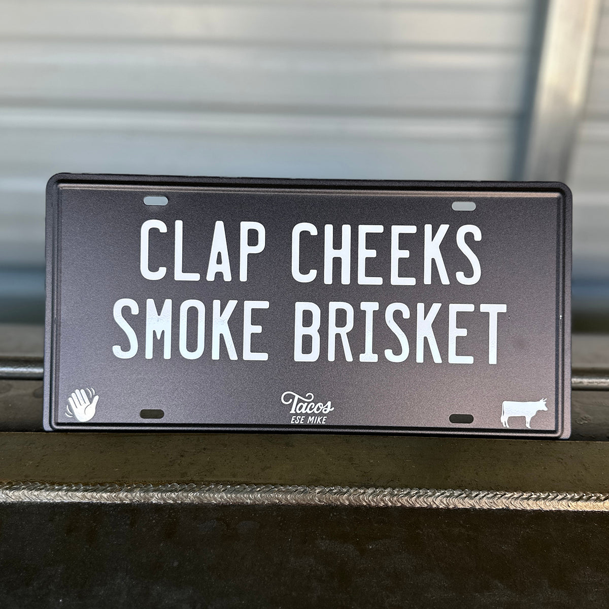 CLAP CHEEKS SMOKE BRISKET - Metal License Plate Sign